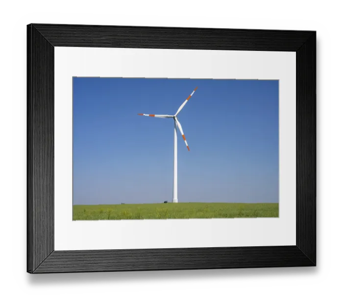 Framed Print : Modern wind turbine against a blue sky in Germany