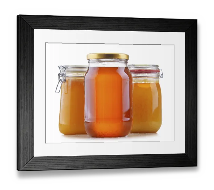 Framed Print : Composition with large jars of honey isolated on white