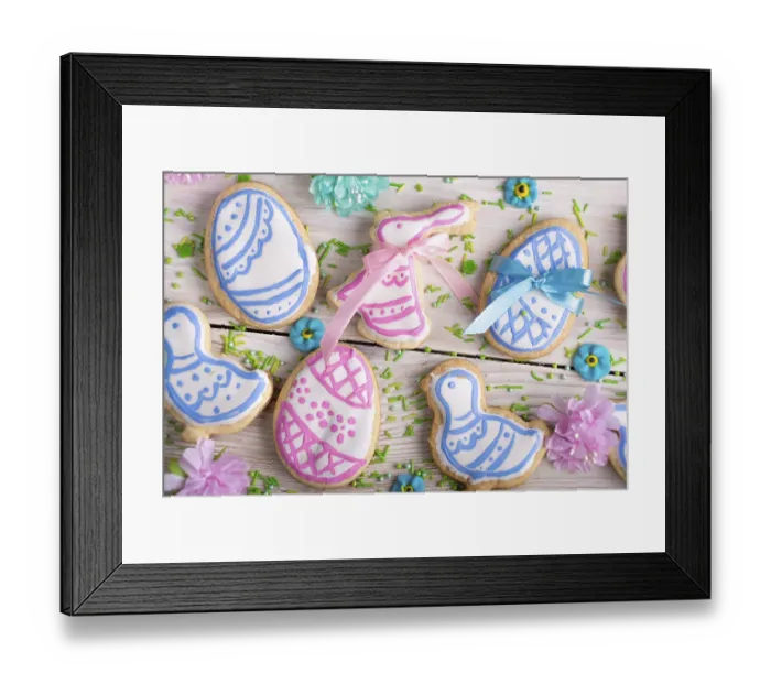 Framed Print : Homemade Easter cookies in shape of eggs chicken and rabbit on white wooden kitchen table flat lay closeup view