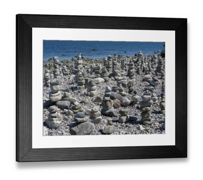 Framed Print : Piled stones on the shore of the island of Stora grundet on the northern tip of the Swedish island of Oland
