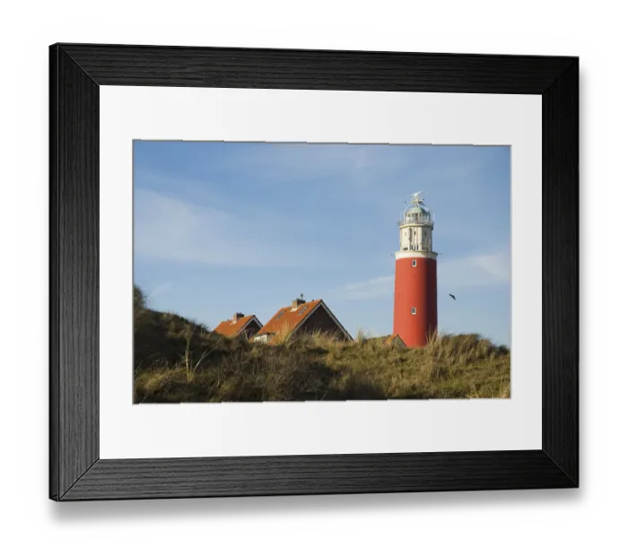 Framed Print : Red lighthouse with small village