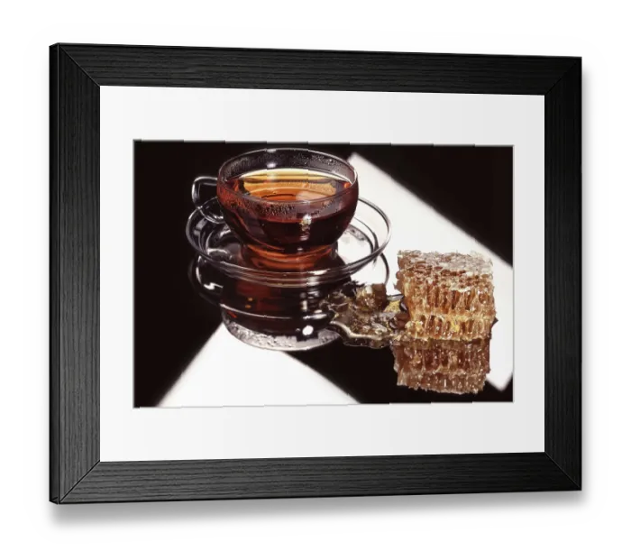 Framed Print : Glass cup of coffee and a piece of honeycombs on a glass background