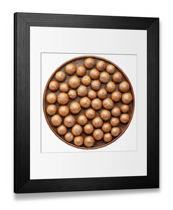Framed Print : Macadamia nuts in shells on on a round wooden tray isolated on white