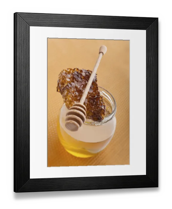 Framed Print : Golden organic honey in glass jar on golden honey comb Framed Print : Golden organic honey in glass jar on golden honey comb