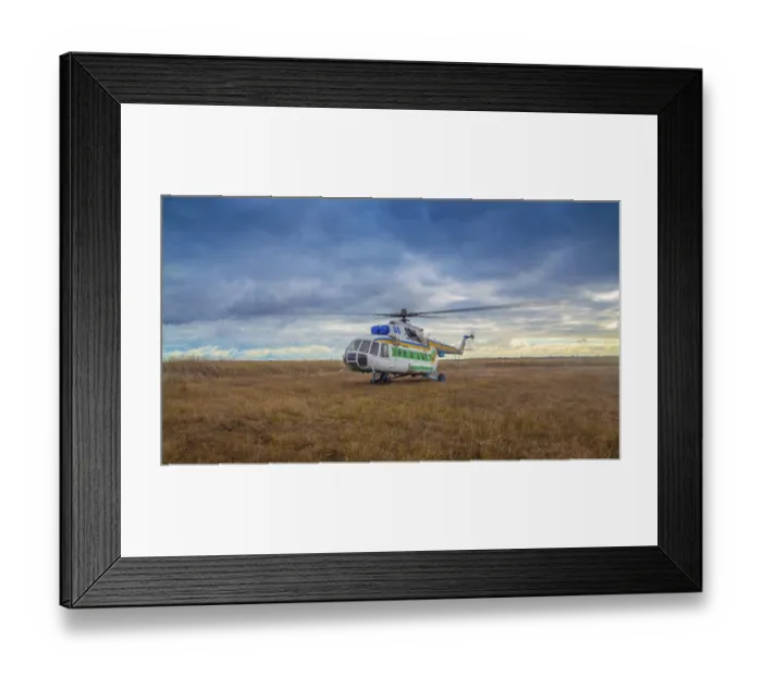 Framed Print : Helicopter taking off in a field against a beautiful sky