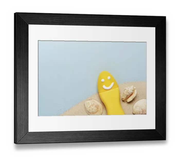 Framed Print : Yellow tube with happy sunscreen face
