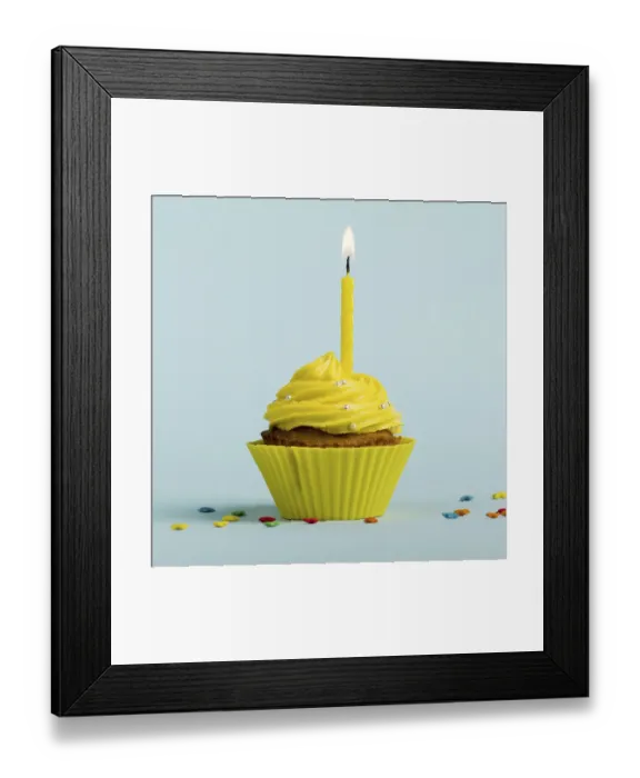 Framed Print : Yellow burning candles decorative muffins with colorful star sprinkles against blue backdrop