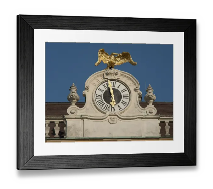Framed Print : Historic clock with gilded eagle on a building against a clear sky Framed Print : Historic clock with gilded eagle on a building against a clear sky