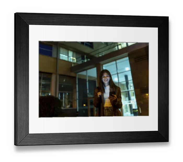 Framed Print : Young woman standing on a city street at night Framed Print : Young woman standing on a city street at night