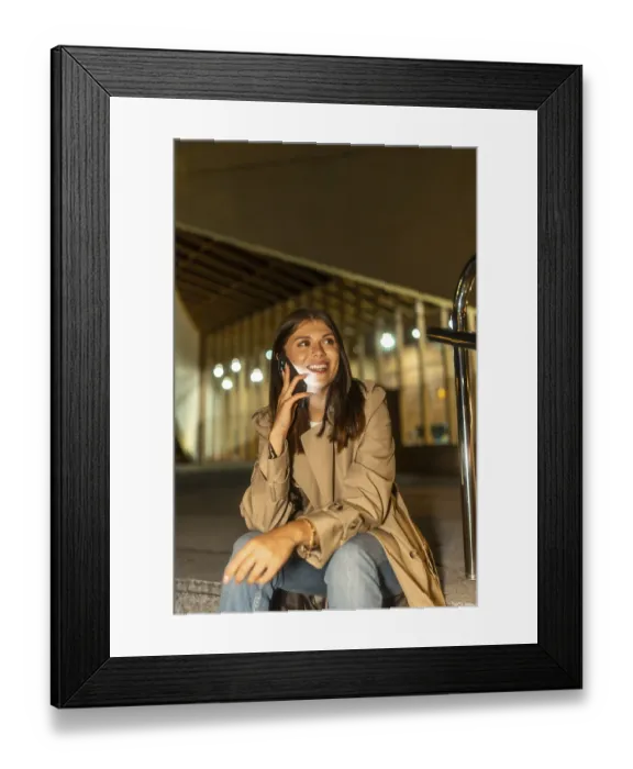 Framed Print : Young woman sitting outdoors at night
