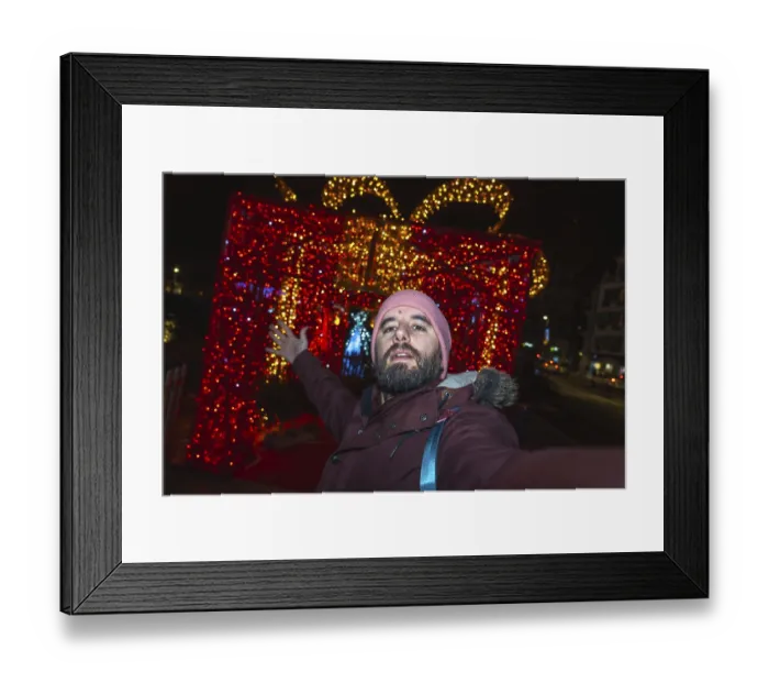 Framed Print : Bearded man taking a selfie in front of giant luminous christmas gift box in bayonne