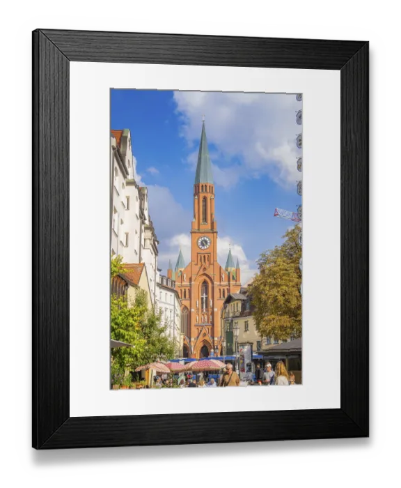 Framed Print : A busy urban centre is dominated by a tall church tower