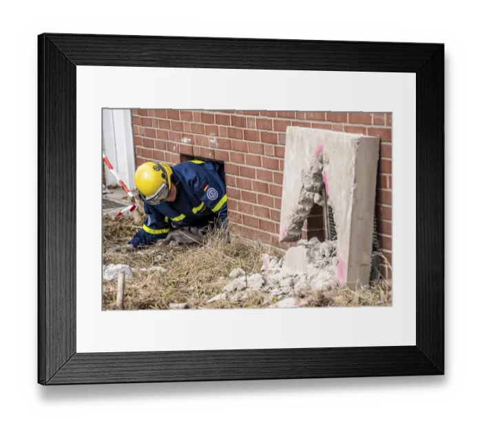Framed Print : Rescue and recovery of people after a drone attack on residential buildings in a civil defence scenario
