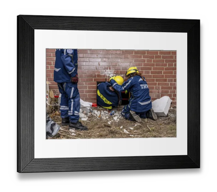 Framed Print : Rescue and recovery of people after a drone attack on a residential building in a civil defence scenario
