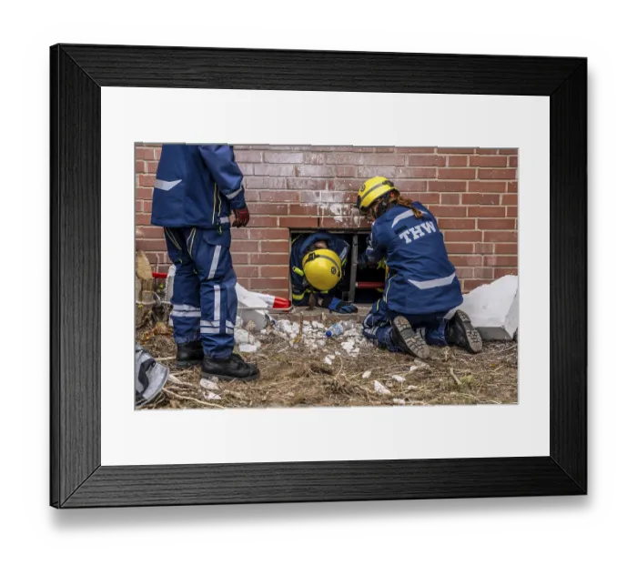 Framed Print : Rescue and recovery of people after a drone attack on a residential building in a civil defence scenario
