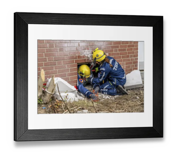 Framed Print : Rescue and recovery of people after a drone attack on a residential building in a civil defence scenario
