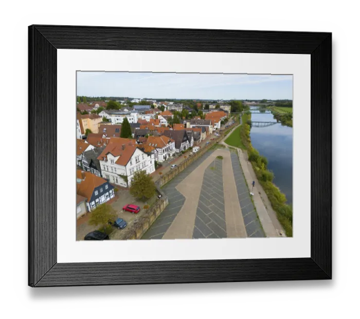 Framed Print : A village with half-timbered houses on the riverbank Framed Print : A village with half-timbered houses on the riverbank