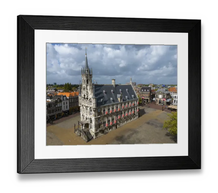 Framed Print : Historic town hall on an empty market square with gothic architecture and cloudy sky
