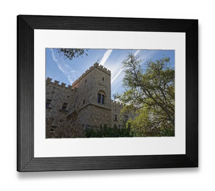 Framed Print : Medieval castle with stone towers under a clear sky and surrounded by trees Framed Print : Medieval castle with stone towers under a clear sky and surrounded by trees