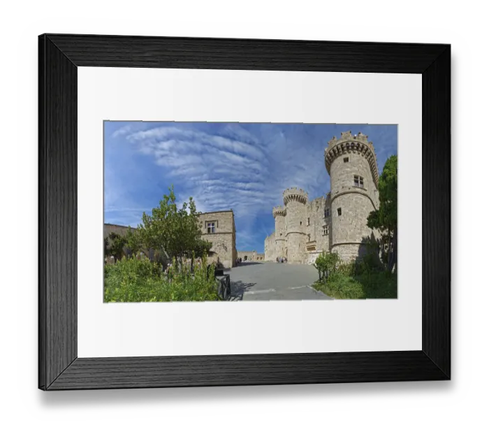 Framed Print : Wide view of a medieval castle with towers and stone walls under a cloudy sky