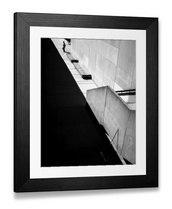 Framed Print : Geometric black and white scene with sharp shadows and a solitary person against a wall in Toronto
