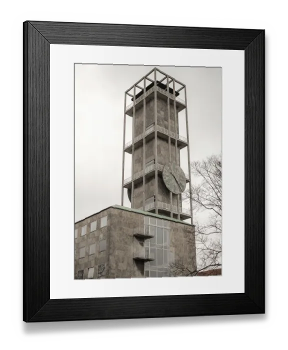 Framed Print : Tall concrete clock tower with minimalistic design against a cloudy sky in Aarhus