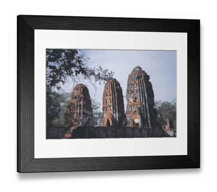 Framed Print : Tall brick ruins and towers reaching towards the sky amidst surrounding trees