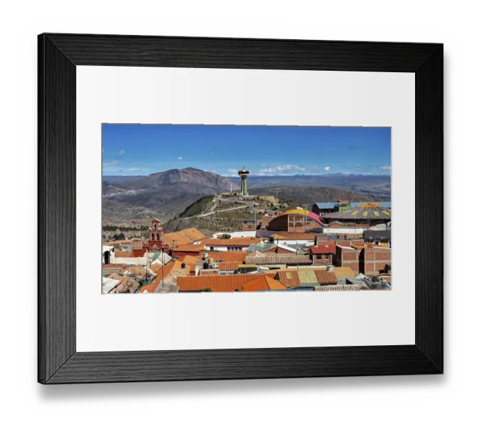 Framed Print : View of orange roofs with a modern building and an antenna in a mountainous environment