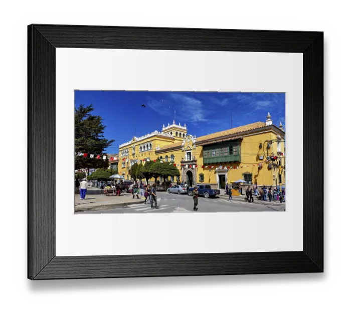Framed Print : Colonial-style building with market scene and decorative flags Framed Print : Colonial-style building with market scene and decorative flags