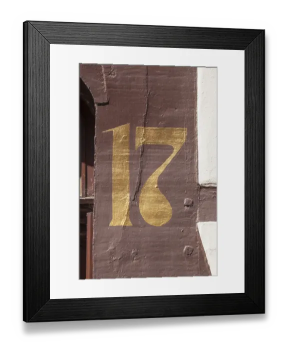 Framed Print : Golden house number plate number seventeen on a half-timbered house in the old town centre