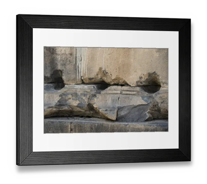 Framed Print : Fragment of a stone wall of an ancient temple made of tufa