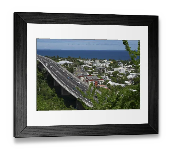 Framed Print : Wide, modern viaduct of the national road RN1 and part of the Route des Tamarins with lively traffic (cars and lorries) Framed Print : Wide, modern viaduct of the national road RN1 and part of the Route des Tamarins with lively traffic (cars and lorries)