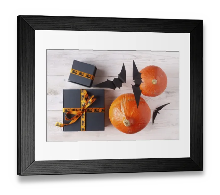 Framed Print : Pumpkin gifts black paper bats on light wood flat lay halloween decor