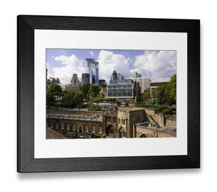 Framed Print : Contrast of modern skyscrapers against historic architecture under a cloudy sky at The Tower of London