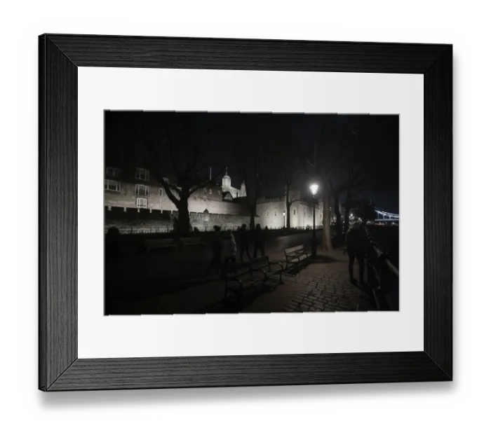 Framed Print : A nighttime view of a historic castle with a path lined by benches and lamps at The Tower of London Framed Print : A nighttime view of a historic castle with a path lined by benches and lamps at The Tower of London