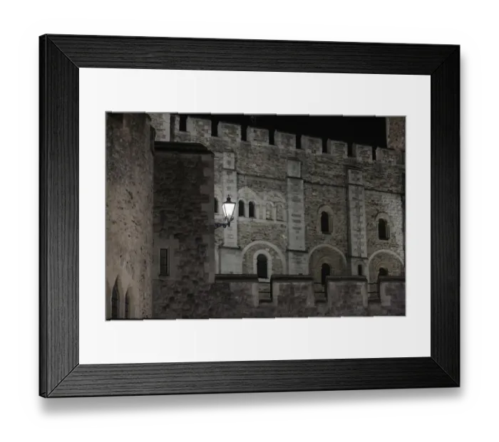 Framed Print : Close-up of a castle's stone wall with intricate architectural details at night at The Tower of London