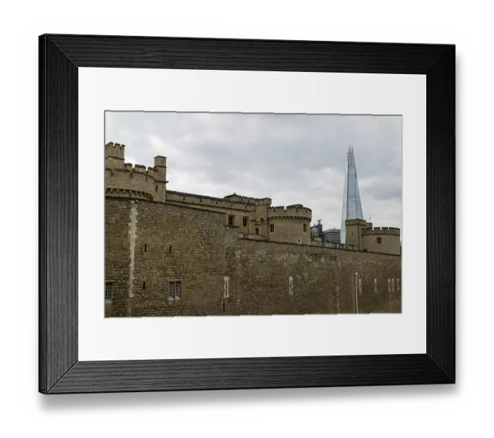 Framed Print : Stone fortress with modern skyscraper in background under cloudy sky at The Tower of London