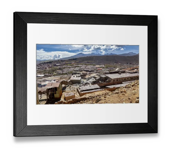 Framed Print : Sweeping views of a valley surrounded by mountains and scattered buildings