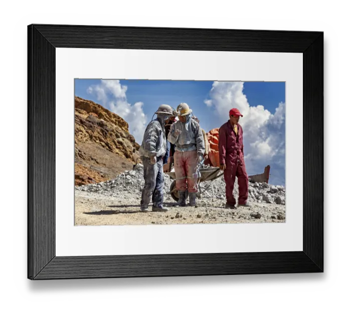 Framed Print : A group of miners stand and chat in a rocky landscape