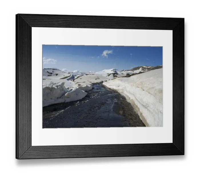 Framed Print : Snow-covered mountains with a road in the foreground under a clear blue sky