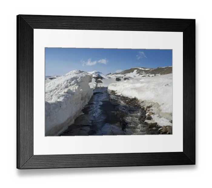 Framed Print : Snow-covered region with a small watercourse and road