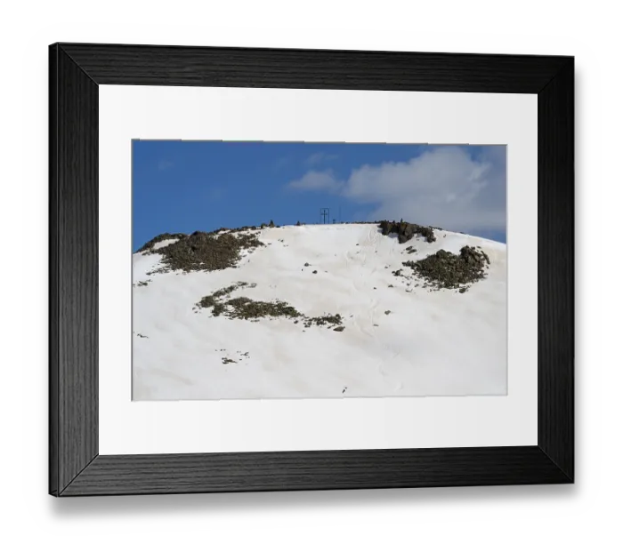 Framed Print : Snow-covered mountain top with rocks