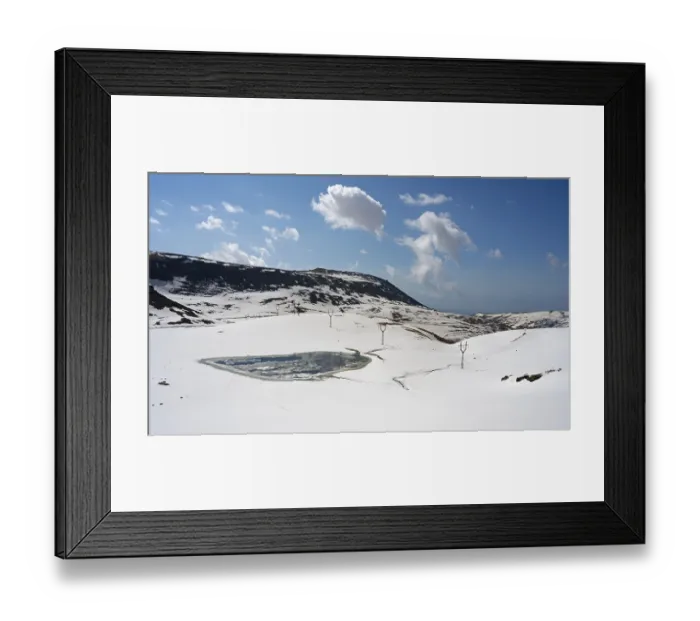 Framed Print : Snowy mountain landscape with calm sky and distant clouds Framed Print : Snowy mountain landscape with calm sky and distant clouds