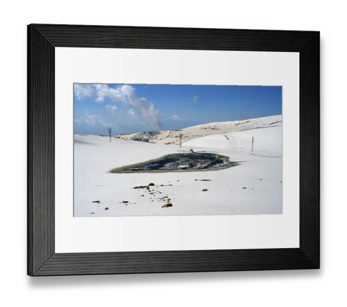 Framed Print : Snowy landscape with frozen lake and light blue sky