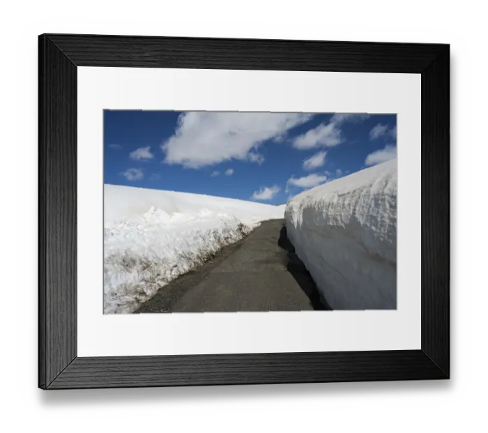 Framed Print : Snow-covered path leading through a white snowy landscape under a blue sky Framed Print : Snow-covered path leading through a white snowy landscape under a blue sky