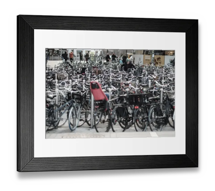 Framed Print : Crowded bicycle parking with numerous bikes lined up tightly along a busy street in Copenhagen Framed Print : Crowded bicycle parking with numerous bikes lined up tightly along a busy street in Copenhagen