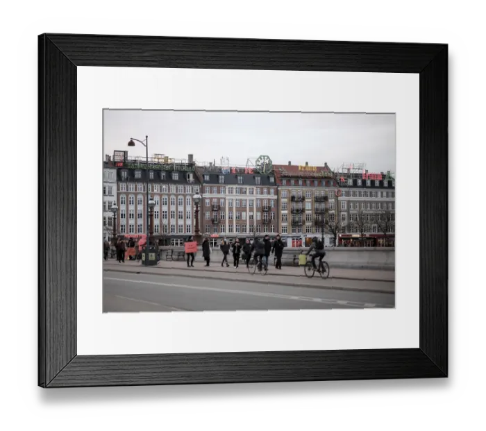 Framed Print : A bustling city street lined with classic buildings under an overcast sky