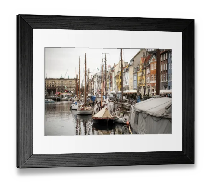 Framed Print : Mooring of several sailboats along a quay with bright