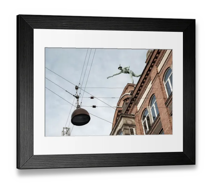 Framed Print : A statue atop a historic building against a backdrop of a clear sky with suspended cables Framed Print : A statue atop a historic building against a backdrop of a clear sky with suspended cables