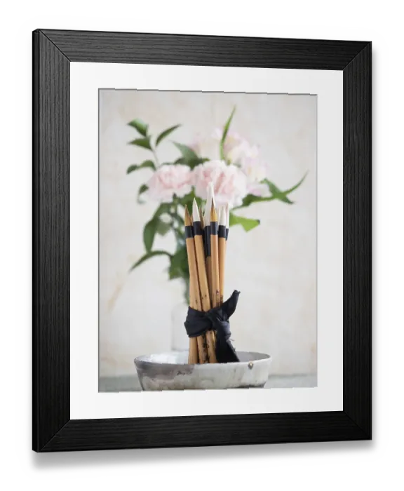 Framed Print : Calligraphy brushes are tied with a black ribbon and placed in a ceramic bowl